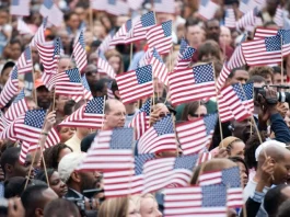 A U.S. flag waving at a political rally during the 2025 presidential campaigns.