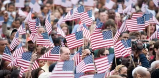 A U.S. flag waving at a political rally during the 2025 presidential campaigns.