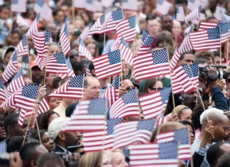 5 Key Issues Defining the 2025 U.S. Presidential Campaigns A U.S. flag waving at a political rally during the 2025 presidential campaigns.
