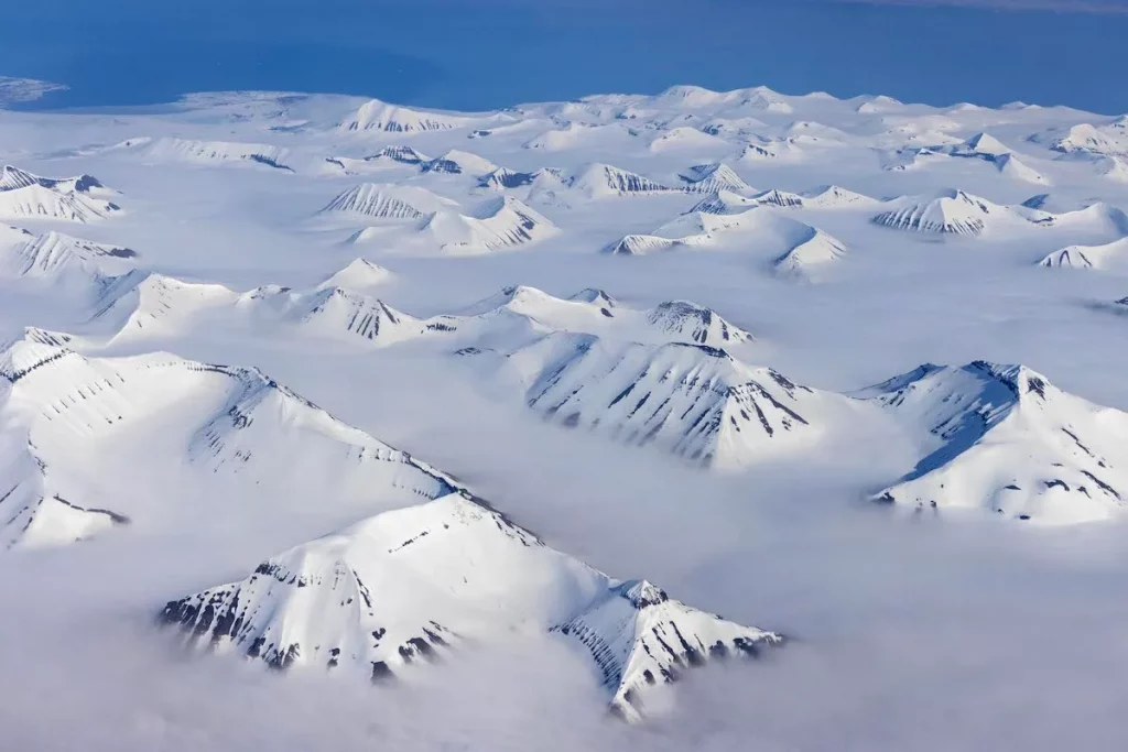 Greenland’s Arctic landscape with icy tundra and mountains.