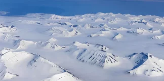 Aerial view of Greenland’s vast ice-covered landscape.