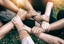 5 Heartwarming Viral Stories That Touched the World in 2025 Hands holding together, symbolizing kindness and humanity.