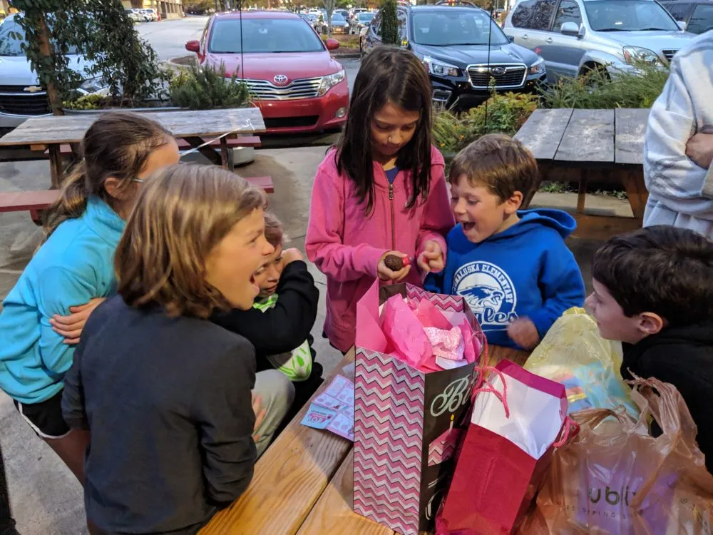 Participants of the Generosity Challenge surprising strangers with gifts.