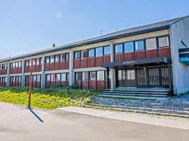Greenland's parliament building in Nuuk, symbolizing its self-governance." Keywords: Greenland parliament, Nuuk government, self-governance.