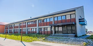 Greenland's parliament building in Nuuk, symbolizing its self-governance." Keywords: Greenland parliament, Nuuk government, self-governance.