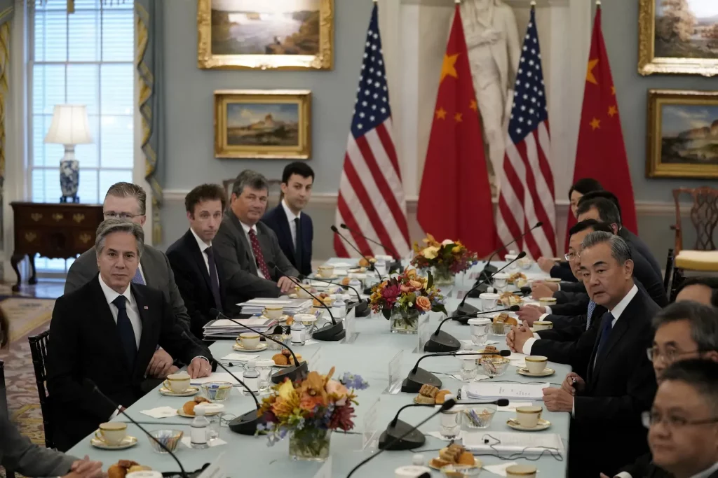 U.S. and Chinese flags in a trade negotiation setting.
