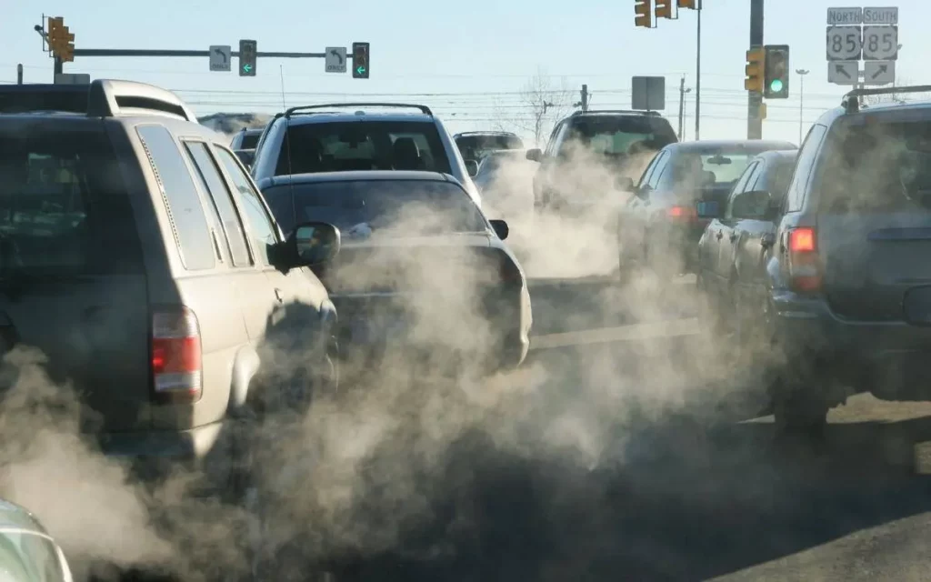 Traffic congestion contributing to air pollution and greenhouse gas emissions.