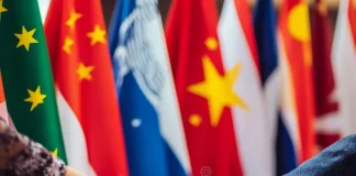 Diplomats shaking hands at an international summit representing global diplomacy.