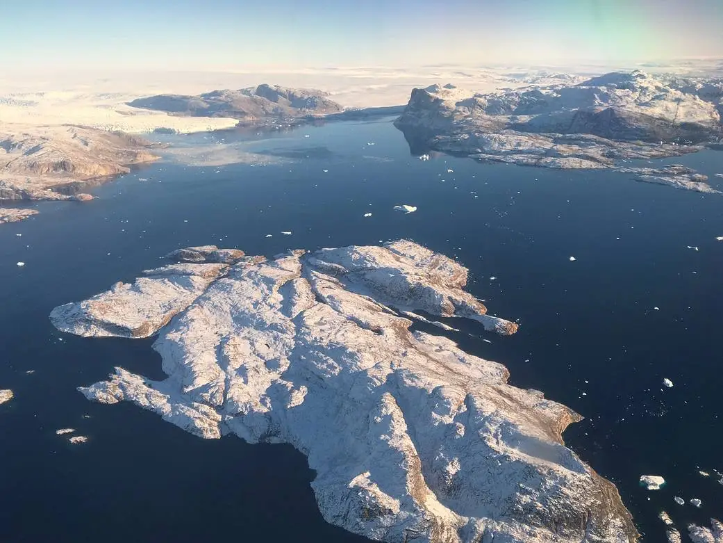 omg_1 Aerial view of Greenland’s vast ice-covered landscape.