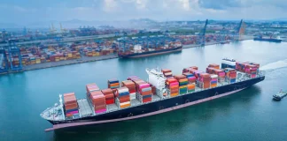 Aerial view of cargo ships and containers at a port.