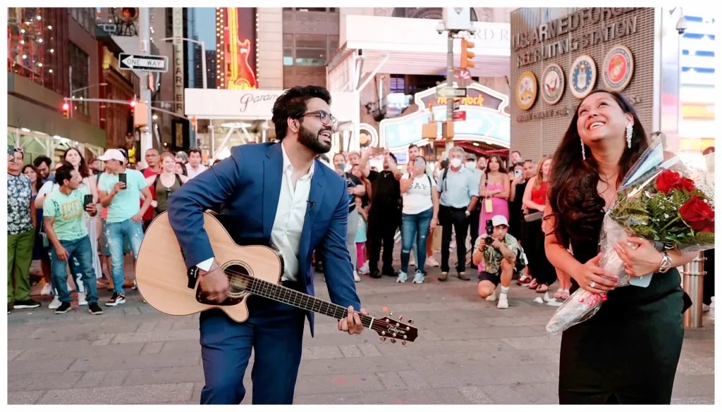 A couple celebrating a viral public proposal in Times Square.