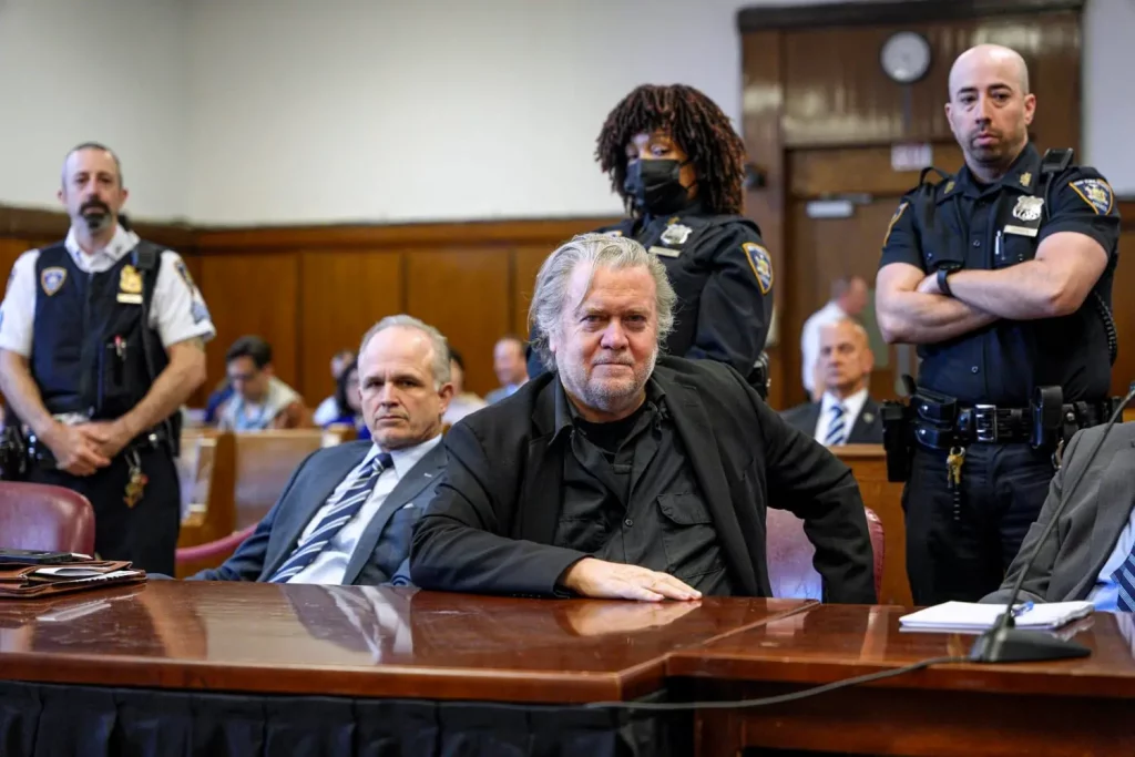 Steve Bannon standing in a courtroom, addressing the judge.