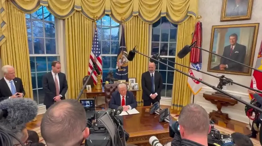 image Trump signing an executive pardon for Rod Blagojevich.