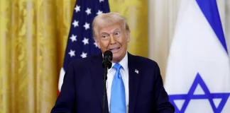 Donald Trump speaking at a rally, addressing impeachment attempts.