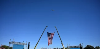 Trump rally crowd cheering as he announces bold border plan.